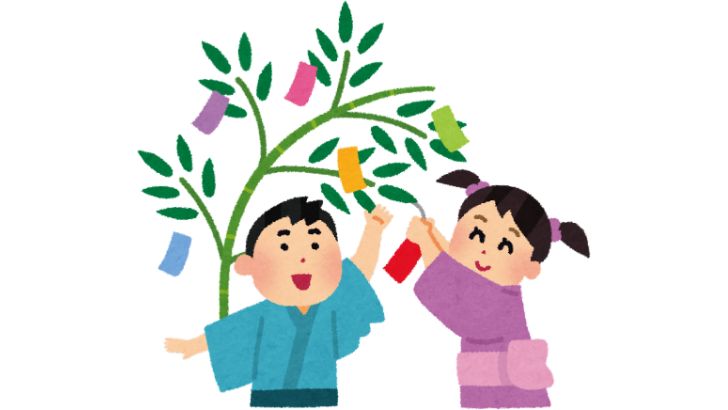 笹に短冊を付けるゆかた姿の男の子と女の子